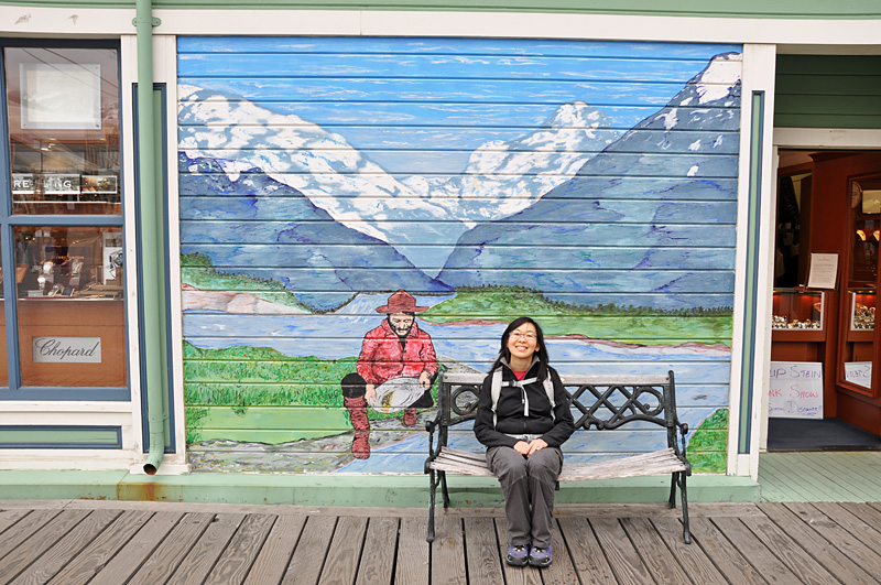 Charlotte sits in front of a nice mural