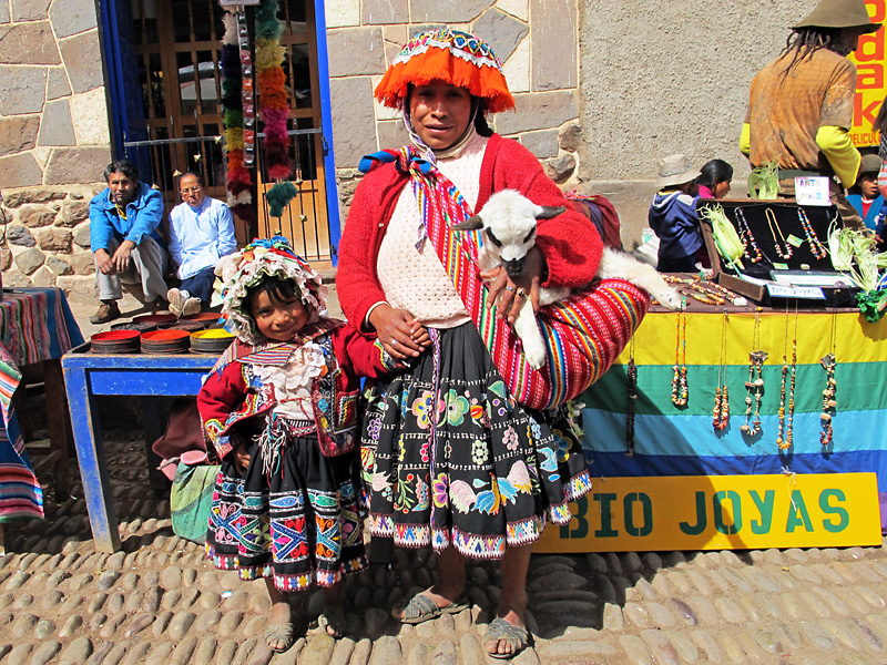 A local lady and daughter with a baby alpaca.jpg