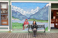 Charlotte sits in front of a nice mural