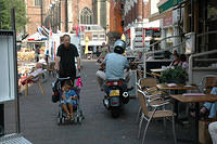 A_baby_stroller_and_motorcycle_share_the_same_sidewalk.jpg