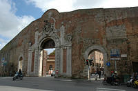 Now_motorcycles_ride_through_the_old_fortress_walls_of_Sienna.jpg